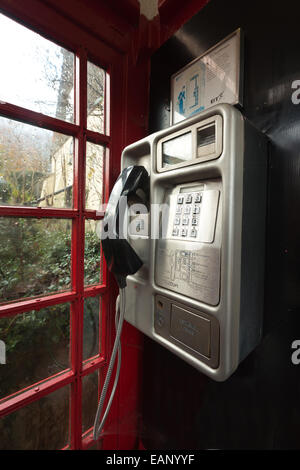 traditional old fashioned unused red telephone box illustrating changing communication cultures and redundant old technology Stock Photo