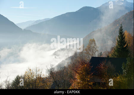 Val D'Arly, Savoie, France. 19th November, 2014. Mist rises as the morning warms up after a cold night. After several days of rainy weather at low altitude and Snow at high altitude the morning breaks with a clear blue sky. Credit:  Graham M. Lawrence/Alamy Live News. Stock Photo