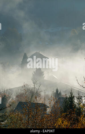 Val D'Arly, Savoie, France. 19th November, 2014. Mist rises as the morning warms up after a cold night. After several days of rainy weather at low altitude and Snow at high altitude the morning breaks with a clear blue sky. Credit:  Graham M. Lawrence/Alamy Live News. Stock Photo