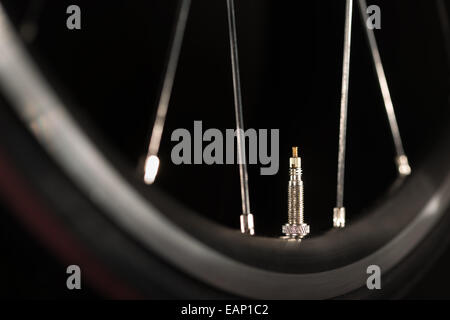 racing road bike wheel rim spokes and valve Stock Photo
