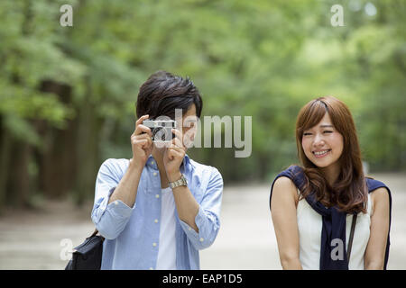 A couple, a man and woman in a Kyoto park, side by side. Stock Photo