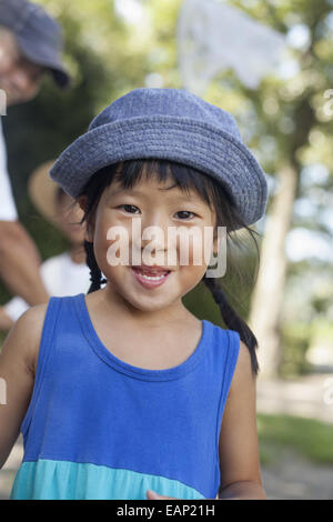 Young girl wearing a summer dress and sun hat. Stock Photo