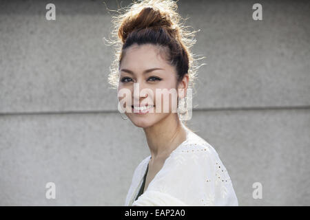 A smiling woman standing outdoors. Stock Photo