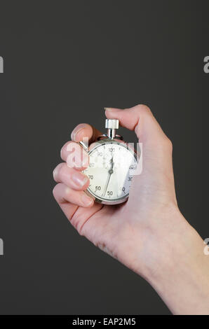 Woman's hand holding a stopwatch Stock Photo