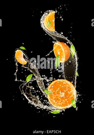 Oranges in water splash, isolated on black background Stock Photo