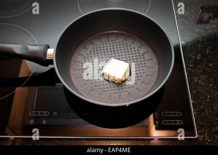 Frying pan on induction hob Stock Photo