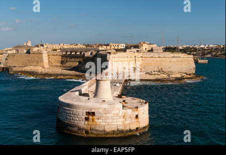 Valletta, Malta - entrance to the Grand Harbour. The Ricasoli lighthouse and breakwater with Fort Ricasoli (Forti Ricazoli) Stock Photo