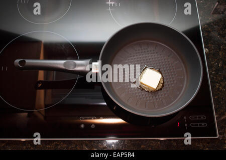 Frying pan on induction hob Stock Photo