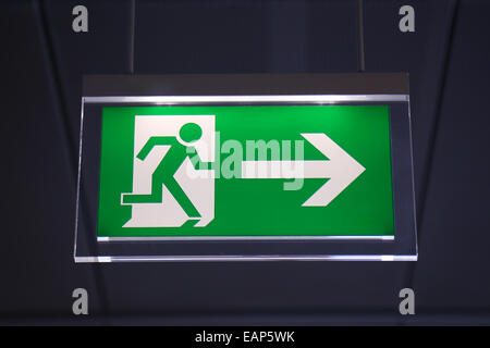 Emergency exit sign above a black doorway Stock Photo