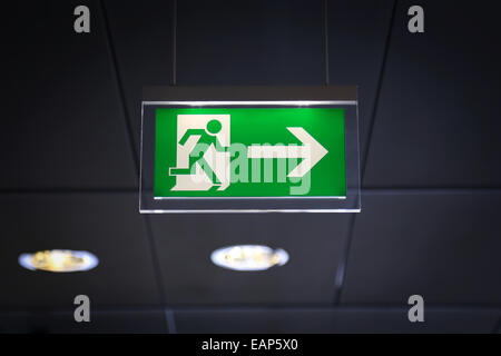 Emergency exit sign above a black doorway Stock Photo