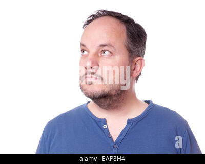middle aged man thinking and looking up to copy space Stock Photo