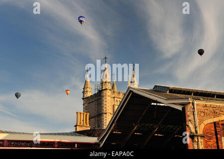 Evening ascent of hot air balloons over Temple Meads station, during the Bristol International Balloon Fiesta. Stock Photo