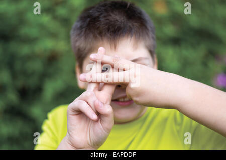 Boy shows sign gesture prison bars Stock Photo