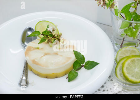 Delicious dessert of lemon pie, table set, decorated with flowers Stock Photo