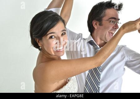 Newly wed hispanic couple dancing Stock Photo