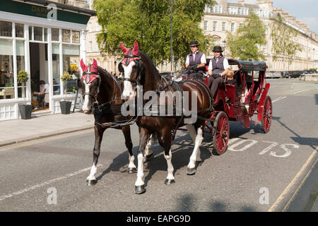 Horse carriage carrying for taking / showing tourist sightseeing passengers around Bath, Somerset UK. Stock Photo