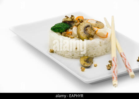 White rice, served in a circular fish with vegetables and mushrooms. white background Stock Photo