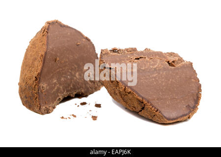 Chocolate truffle cut in half isolated over white background Stock Photo
