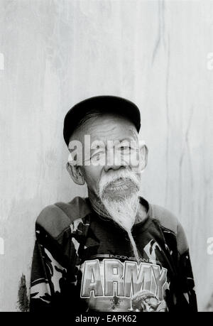 Elderly traditional Indonesian man in Yogyakarta in Java in Indonesia in Southeast Asia Far East. Reportage Photojournalism Portrait People Travel b&w Stock Photo