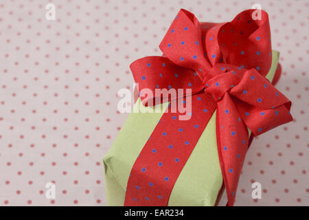 red and blue polka dot gift box with ribbon and bow Stock Photo