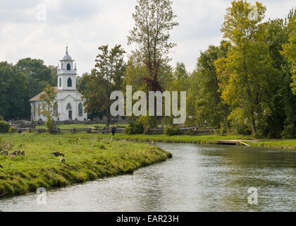 The Village Church with stream. The white clapboard village church with the small village stream running in front of it. Stock Photo