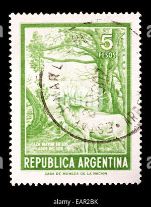 Postage stamp from Argentina depicting a red deer in a forest. Stock Photo