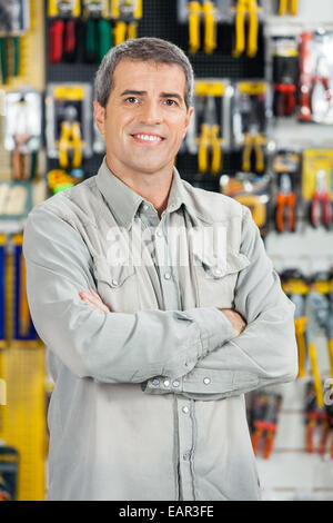 Happy Man Standing Arms Crossed In Hardware Store Stock Photo