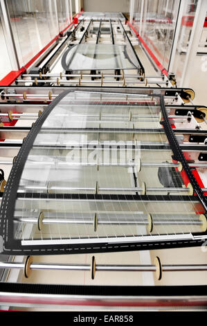 Industry detail with a rear car glass on the production line in a glass factory Stock Photo