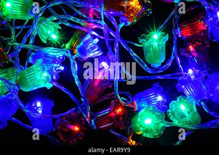 Modern Christmas LED Canterbury bells lights against a black background. Stock Photo