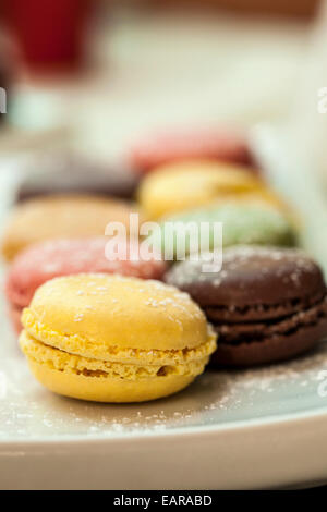 Colourful macaroons on a plate. Modern tapa. Stock Photo