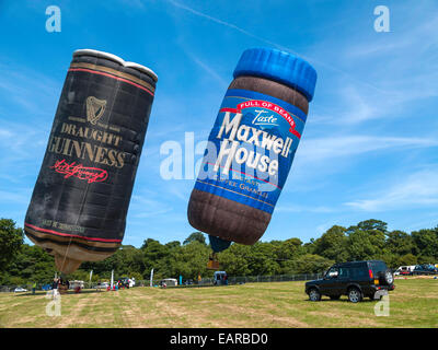 Two hot air balloons shaped as a Guinness beer can and a Maxwell House coffee jar at launch Stock Photo