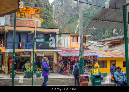 People walking on the streets near the tracks of Aguas Calientes, Peru Stock Photo