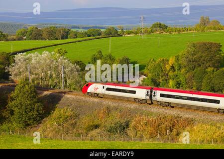 Class 390 Pendolino Virgin train passing Strickland Mill, Great Strickland, Cumbria, West Coast Main Line, England, UK. Stock Photo