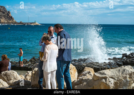 Tourists walking along the Arenal of Javea Port, Spain. Stock Photo