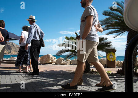 Tourists walking along the Arenal of Javea Port, Spain. Stock Photo