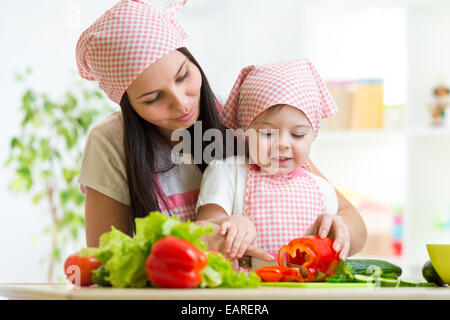 Mother teaches daughter on kitchen Stock Photo