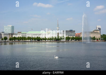 View over the Inner Alster Lake with Alster Fountain and an Alster swan towards the street of Neuer Jungfernstieg, Hotel Vier Stock Photo