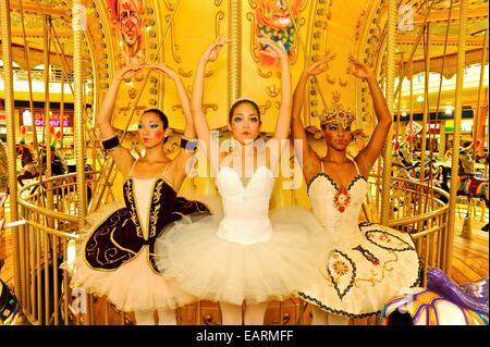 National Ballet of Panama dancers pose as dolls at a merry go round. Stock Photo