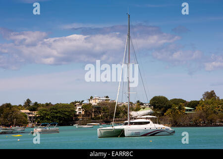 Mauritius, Grand Baie, public beach, sailing catamaran moored in sheltered bay Stock Photo