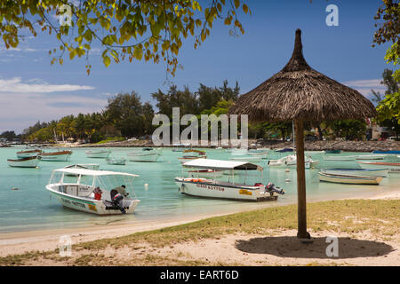 Mauritius, Grand Baie, public beach, glass bottom boat moored in sheltered bay Stock Photo