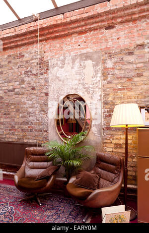 Two leather armchairs in room, Dalston eclectic taxidermy warehouse and locations studio in East London Stock Photo