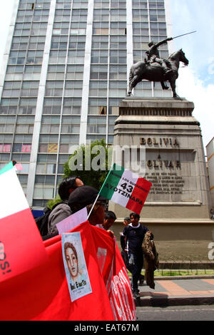 La Paz, Bolivia. 20th November, 2014. Protesters pass a statue of Simón Bolivar during a march to demand justice for the 43 missing students in Mexico and protest against the Mexican government's handling of the case and corruption. Today has been designated a Global Day of Action for Ayotzinapa; a national strike is planned in Mexico and many protests are taking place worldwide to show support. The students disappeared after clashing with police on the night of 26th September in the town of Iguala. Credit:  James Brunker/Alamy Live News Stock Photo