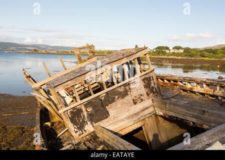 An old fishing boat run aground at Salen on the Isle of Mull, Scotland, UK. Stock Photo