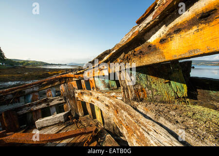 An old fishing boat run aground at Salen on the Isle of Mull, Scotland, UK. Stock Photo