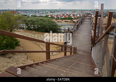 The wooden footbridge Het Wrakhout and holiday resort along the North Sea coast at Westende, West Flanders, Belgium Stock Photo