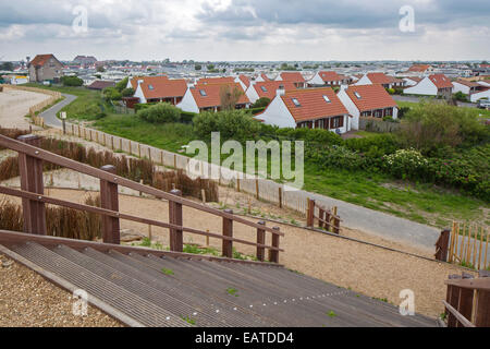 The wooden footbridge Het Wrakhout and holiday resort along the North Sea coast at Westende, West Flanders, Belgium Stock Photo