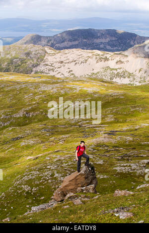 A teenager climbing the Munro on Ben More, Isle of Mull, Scotland, UK. Stock Photo