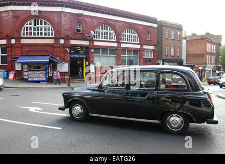 London cab outside Hampstead underground station, London United Kingdom Stock Photo