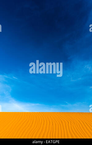Geometric ripples in the face of a red sand dune in a coastal desert. Stock Photo