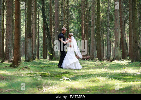 bride and groom shooting at the wedding in the forest Stock Photo